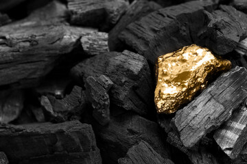 Fototapeta Shiny gold nugget on coals, closeup view obraz