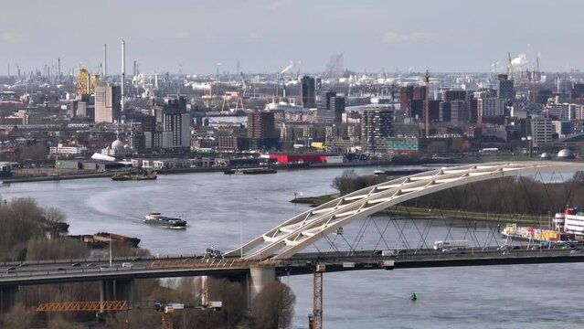 Traffic flow over Van Brienenoord bridge, Rotterdam skyline aerial view; Holland