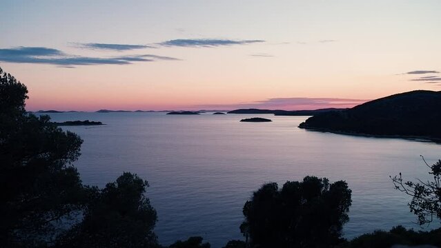Beautiful calming colors over tranquil Adriatic sea after sunset, Kornati islands visible in background. Croatia, vacation and travel concepts, HD