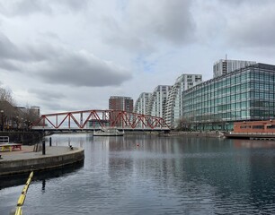 Naklejka premium Modern buildings next to the river with reflections in the water. Salford Quays England. 