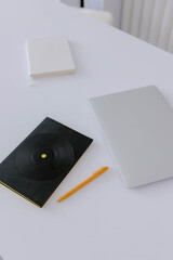 Black notepad and gray laptop on the table