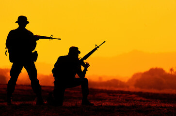 silhouette of soldier with rifle.soldiers in the uniform.soldier in action.