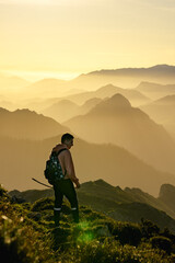 Hiker in the mountain during a gold sunset