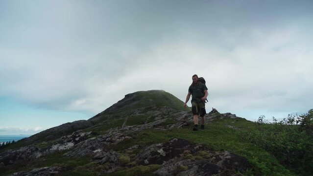 Norwegian Guy With Backpack On The Hiking Trails In Lur&oslash;yfjellet, Norway. Low Wde Shot