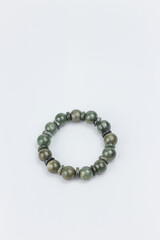 Bracelet made of natural green malachite on white background