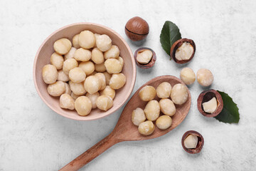 Delicious organic Macadamia nuts on light gray table, flat lay