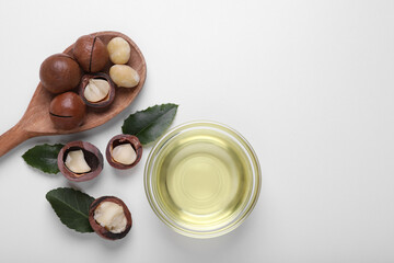 Obraz na płótnie Canvas Delicious organic Macadamia nuts and natural oil on white background, flat lay. Space for text