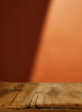 Desk of free space and orange wall with shadows 