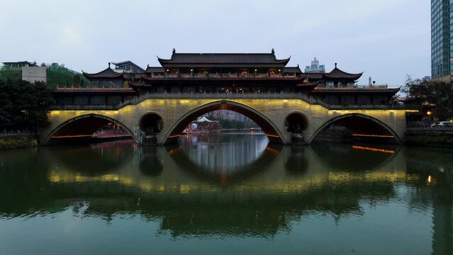 Anshun Bridge Illuminated at Night in Chengdu, China over Jin River - Aerial Drone Flight