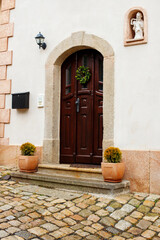 Fototapeta na wymiar Restored Vintage Wooden Doors in Old European City: Heritage Architecture and Craftsmanship