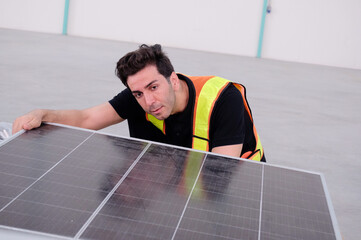 Engineer checking solar panels in a warehouse.
