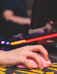Cyber sport e-sports tournament, team of professional gamers, gamer's hands on mouse and keyboard, pushing button, gamers playing in competitive moba, strategy fps game in a cyber games arena club