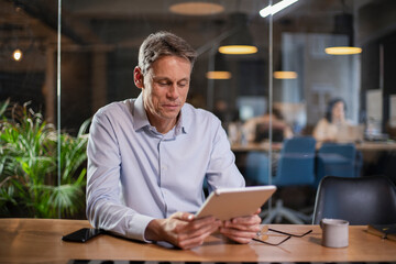 Portrait of businessman in office. Man using digital tablet. Businessman having video call.