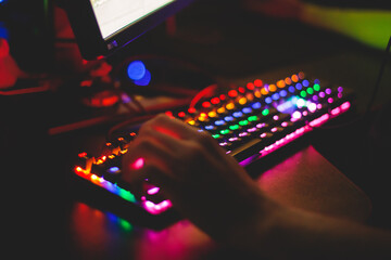 Cyber sport e-sports tournament, team of professional gamers, gamer's hands on mouse and keyboard, pushing button, gamers playing in competitive moba, strategy fps game in a cyber games arena club © tsuguliev