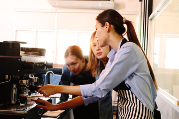 An experienced female barista in uniform will demonstrate how coffee is made and provide a master class. Small business and cafe owner concept