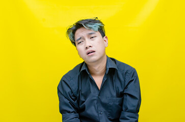 portrait of Asian man in pensive mood looks stressed, depressed, sad and messed up. An irritated man in a rage situation. stressed over the work concept.