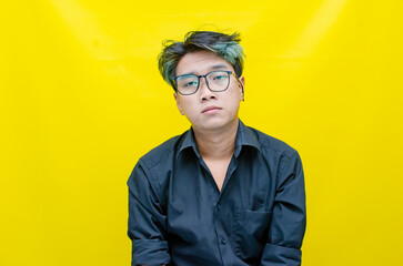 portrait of Asian man in pensive mood looks stressed, depressed, sad and messed up. An irritated man in a rage situation. stressed over the work concept.