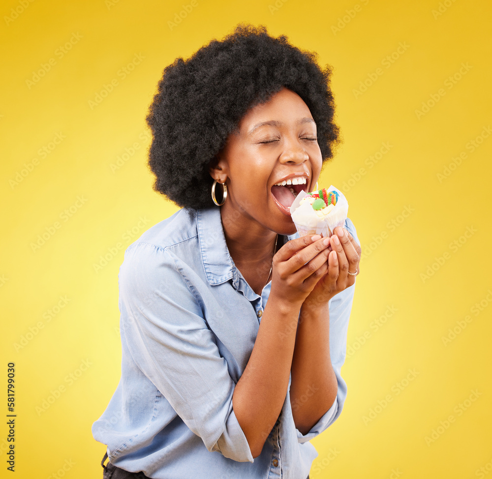 Sticker black woman, cupcake and excited or happy in studio while eating sweet food on a yellow background. African female model with snack, dessert or cake for happiness, birthday or celebration mockup