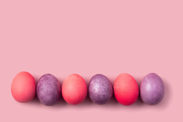 Easter card with colorful eggs on a pink background