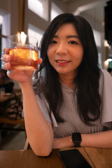 Asian female holding cocktails 