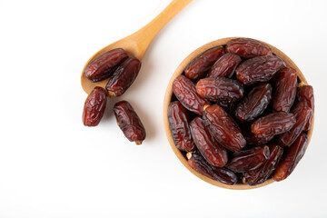Date fruits in wooden bowl,on white background,top view