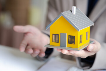 Real estate agents explain models of housing estates in projects to elaborate to clients,...