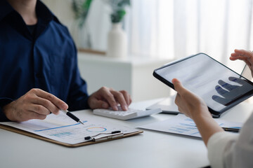Group business people are brainstorming together and reviewing the company financial documents that the finance department has summarized, they are business partners. Business administration concept.