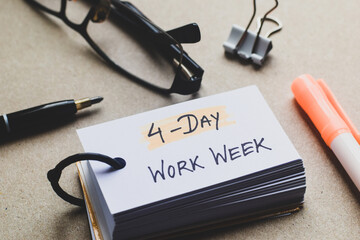 Four day Work week handwritten text on ring note on desk. Selective focus.