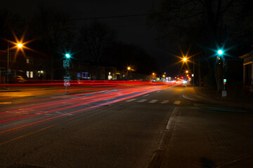 Boulevard in Montreal, Canada, at night with a lot of passing cars that leave a tray of light