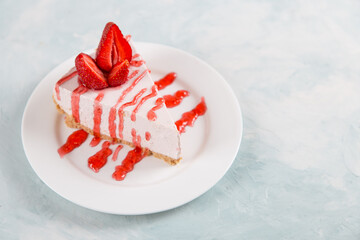 Sweet breakfast, delicious cheesecake with fresh strawberries and mint, homemade recipe without baking, on a blue stone table. Copy space.