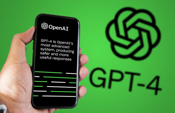 Hand Holding A Phone With The OpenAI GPT-4 Website On The Screen