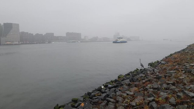 Ferry crossing the river IJ in Amsterdam, The Netherlands on a foggy morning.