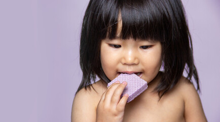 cute asian girl kid enjoy eating vafer snack on isolate