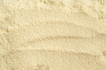 Beige background made of almond flour