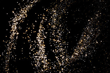 Golden and silver blurred bokeh lights on black background. Glitter sparkle stars for celebrate. Overlay for your design