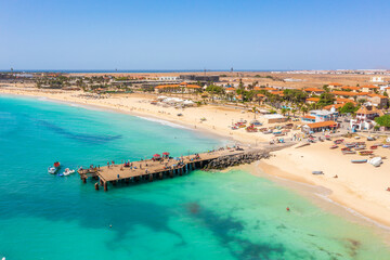 Pier and boats on turquoise water in city of Santa Maria, Sal, Cape Verde