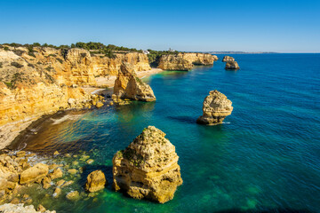 Fototapeta na wymiar Beautiful cliffs and rock formations at Marinha Beach in Algarve, Portugal