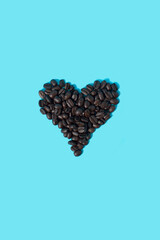 Coffee beans make a heart shape on a blue background. I love coffee concept.