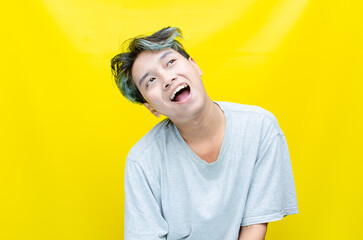 Crazy Happy Asian Man with funny Hairstyle making Grimace Silly funny freak face. man in peek a boo...