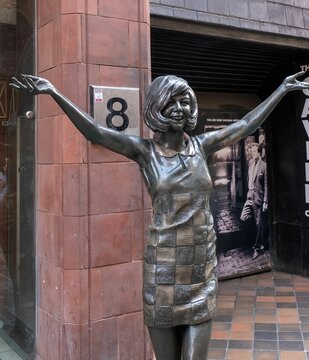 Vertical shot of the statue of Cilla Black on Mathew Street outside the entrance to the Cavern Club