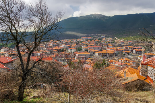 Agios Athanasios, Greece traditional village with red tile rooftops on low rise stone-built houses.