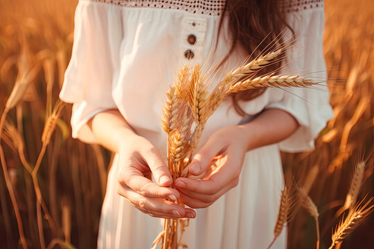 Celiac disease and gluten intolerance, woman holding spikelet of wheat