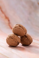 Raw of walnuts in shell with blur background, vertical shot