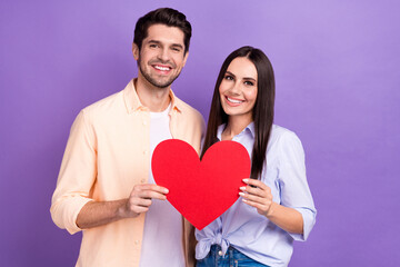 Fototapeta na wymiar Photo of pretty cute couple wife husband together hold red paper big symbol celebrate anniversary valentine day isolated on purple color background