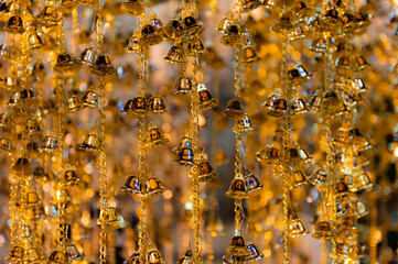 Blurry image with  selected focus of little Bells for good fortune, in a Temple at the Wat Arun Temple complex in Bangkok, Thailand.