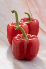 Closeup of three whole red bellpeppers