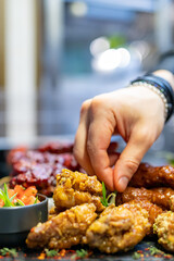 Chef cooking set of assorted grilled meat platter with differend chicken and vegetables salad on restaurant kitchen