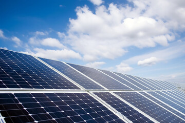 Solar panels on a roof with blue sky and a few clouds. Green energy by sun. Created with AI	