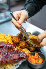 Chef cooking set of assorted grilled meat platter with differend chicken and vegetables salad on restaurant kitchen
