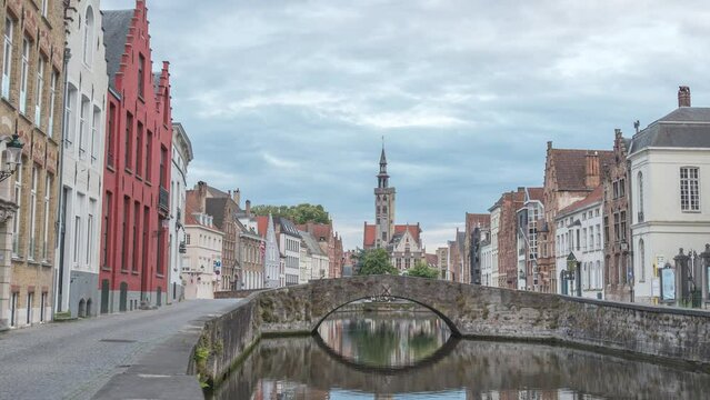 Bruges Belgium time lapse 4K, city skyline day to night timelapse at Spiegelrei Canal with King's Bridge (Koningsbrug)